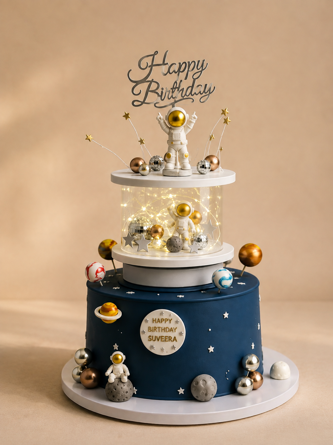 Three-tier space-themed birthday cake with astronauts, planets and illuminated center tier