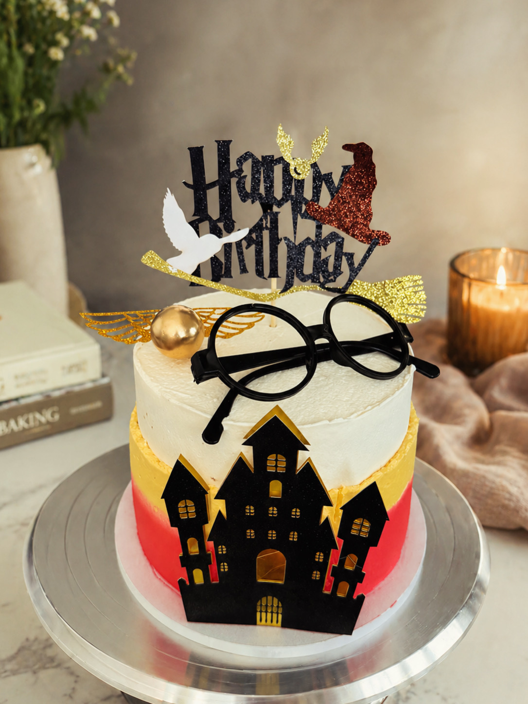 Wizard-themed birthday cake with castle silhouette, glasses and topper